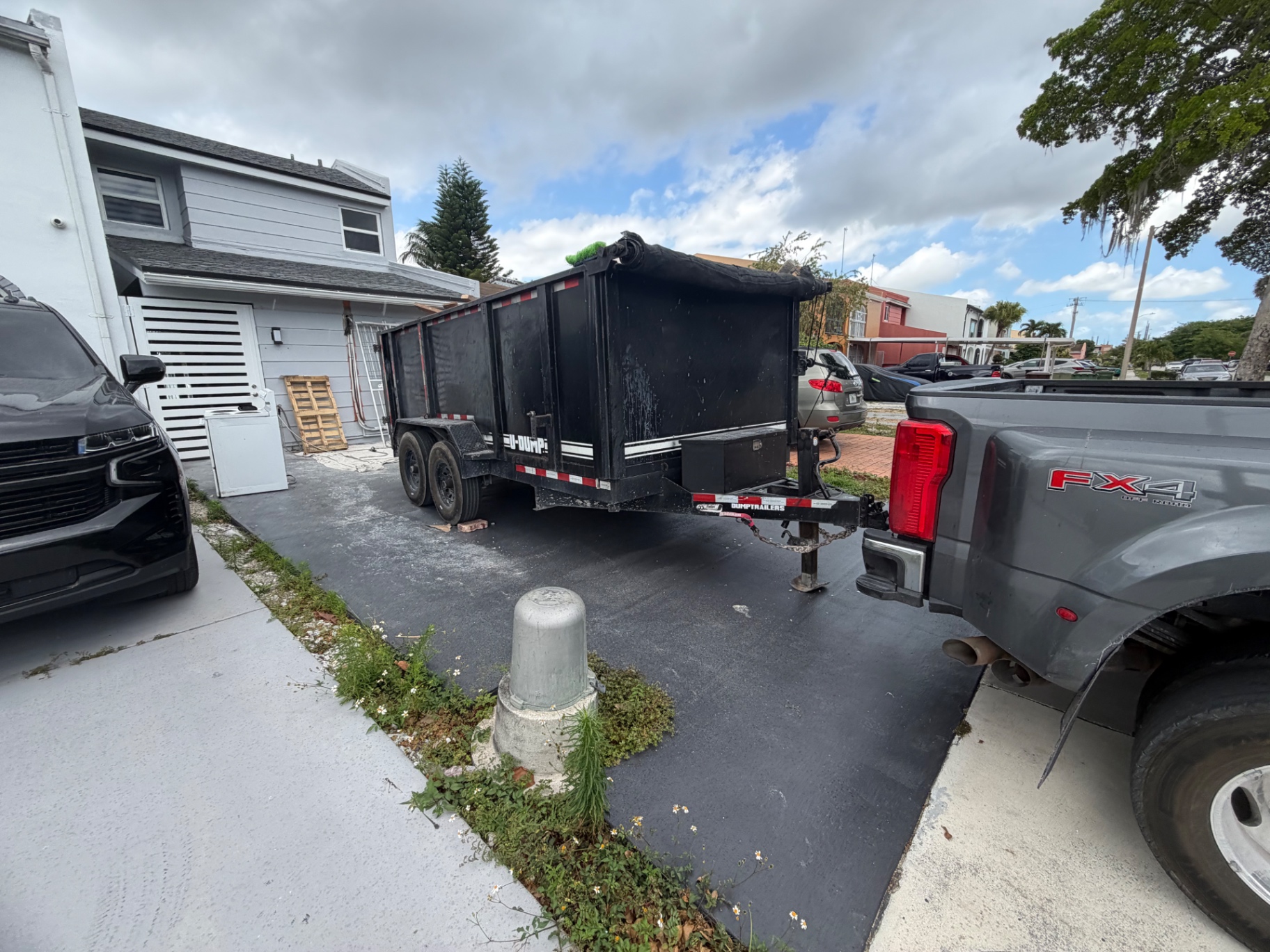 Dump trailer staged in a residential driveway
